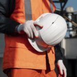 close up hand holding safety helmet scaled 2